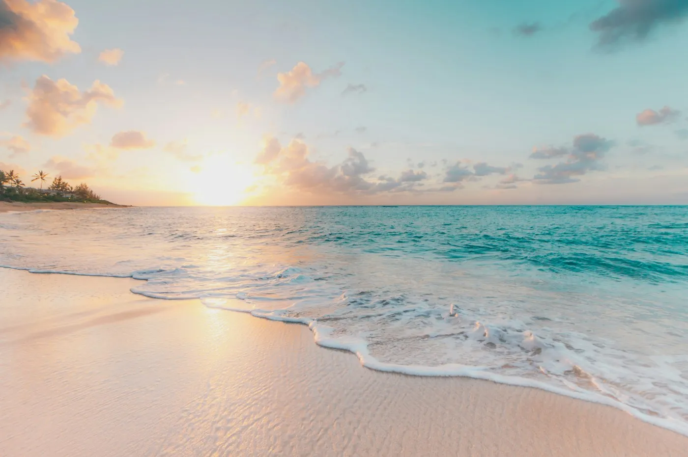 A traveler wading into clear Caribbean water