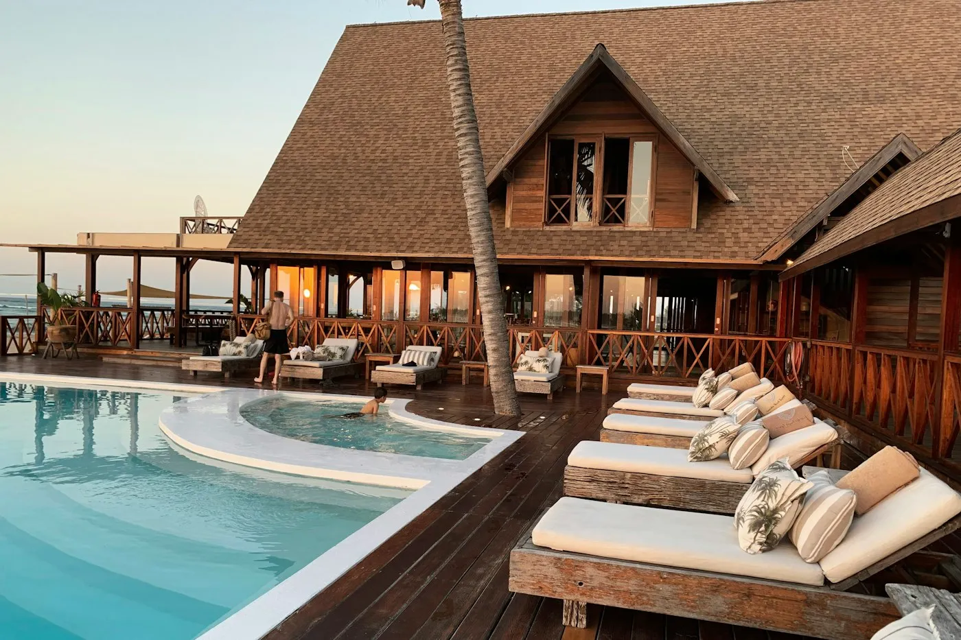 A warmly lit boutique hotel room with thoughtful details