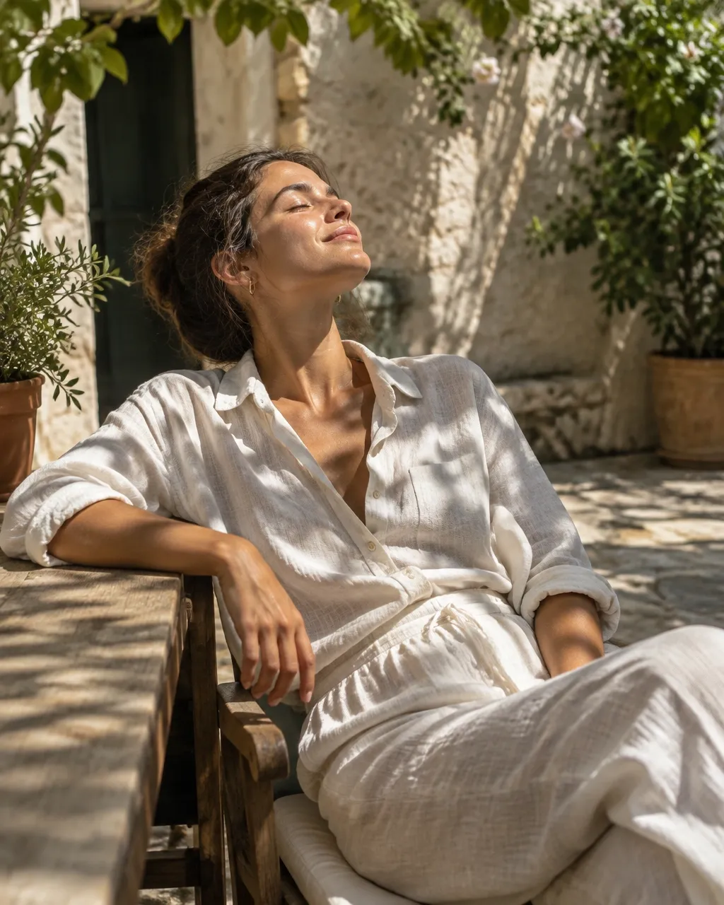 A traveler relaxing in a bright courtyard with leafy shadows